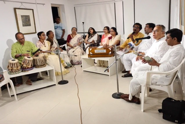 Group of seniors singing and enjoying music with tabla and harmonium at Aumorto retirement living community in West Bengal