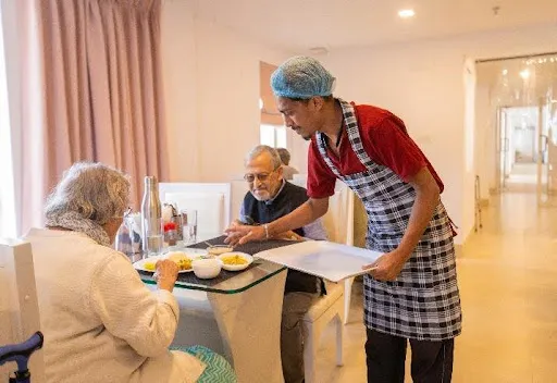 seniors enjoying healthy food at senior citizen homes