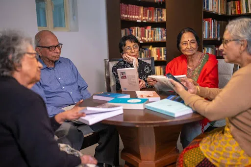 Group of seniors attending an educational workshop, showing knowledge-focused activities in Future living homes.