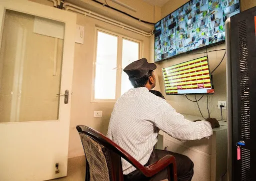 Modern retirement home in Kolkata with on-site security monitoring cameras for senior safety and health care.