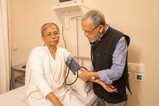 Senior receiving regular health monitoring and medical support at a future living home in West Bengal.